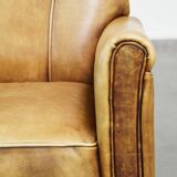 Unique children’s armchair made of cowhide leather in Art Deco style, featuring a light cognac color