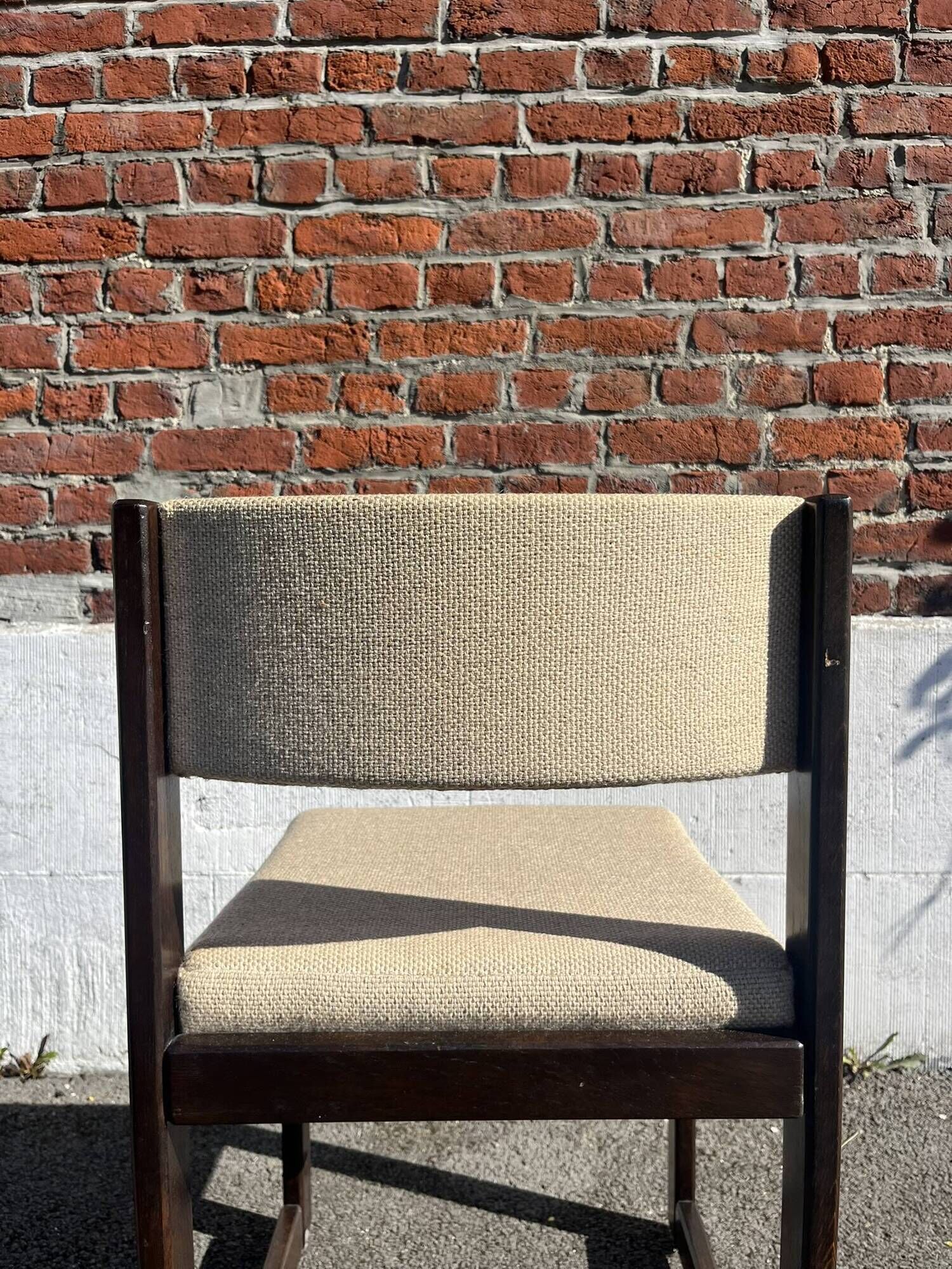 Many mid-century vintage wooden and fabric chairs.