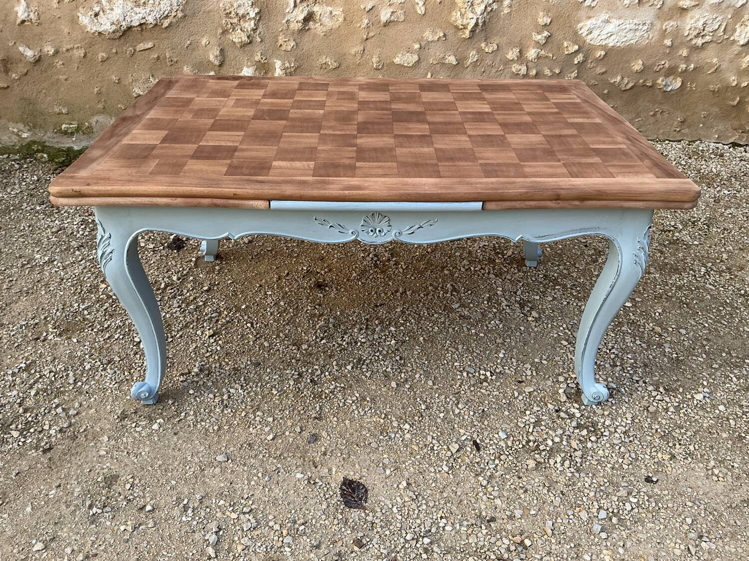Louis XV style walnut table with a natural wood top.