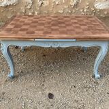 Louis XV style walnut table with a natural wood top.