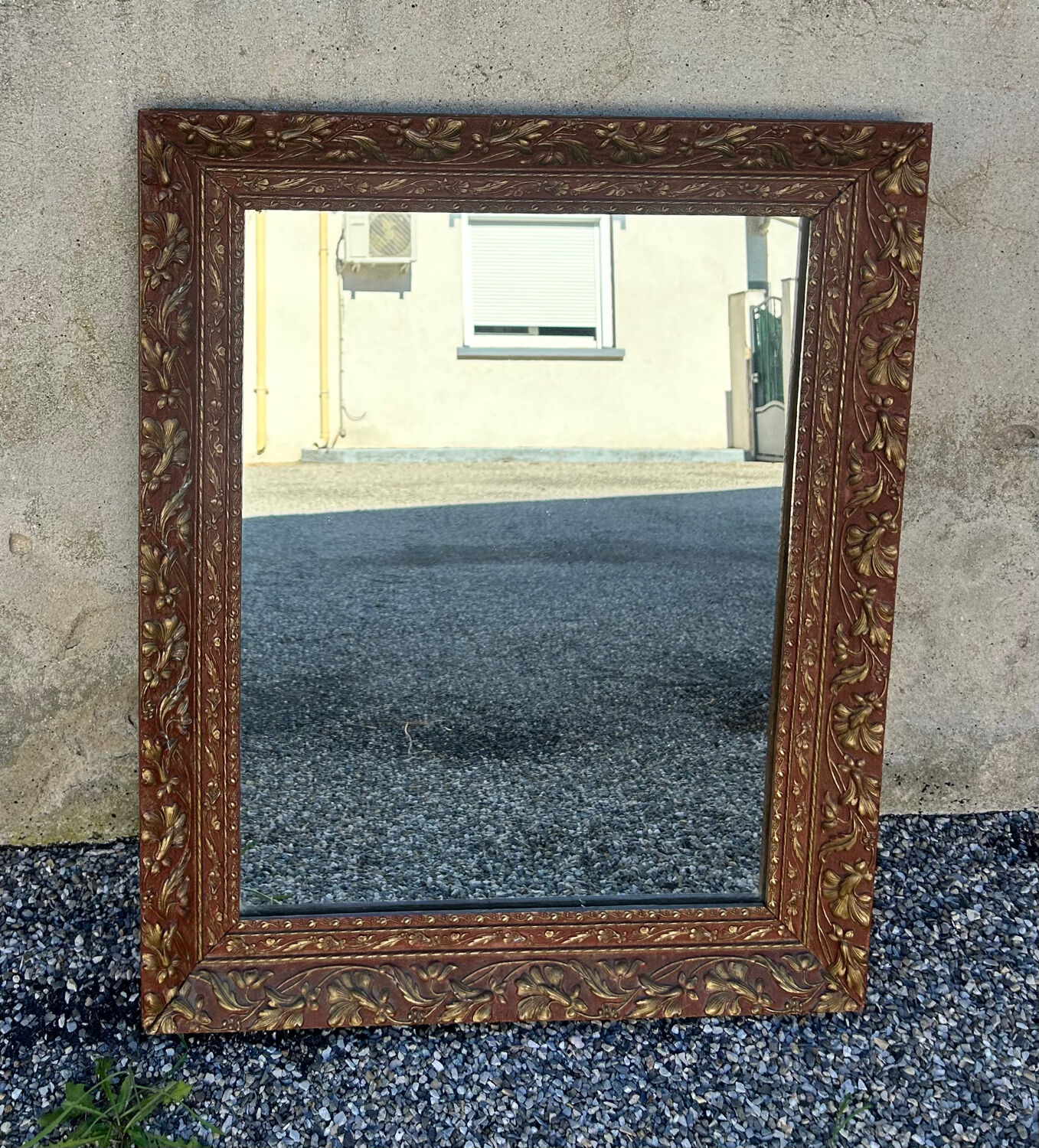 Antique mirror in patinated gilt wood