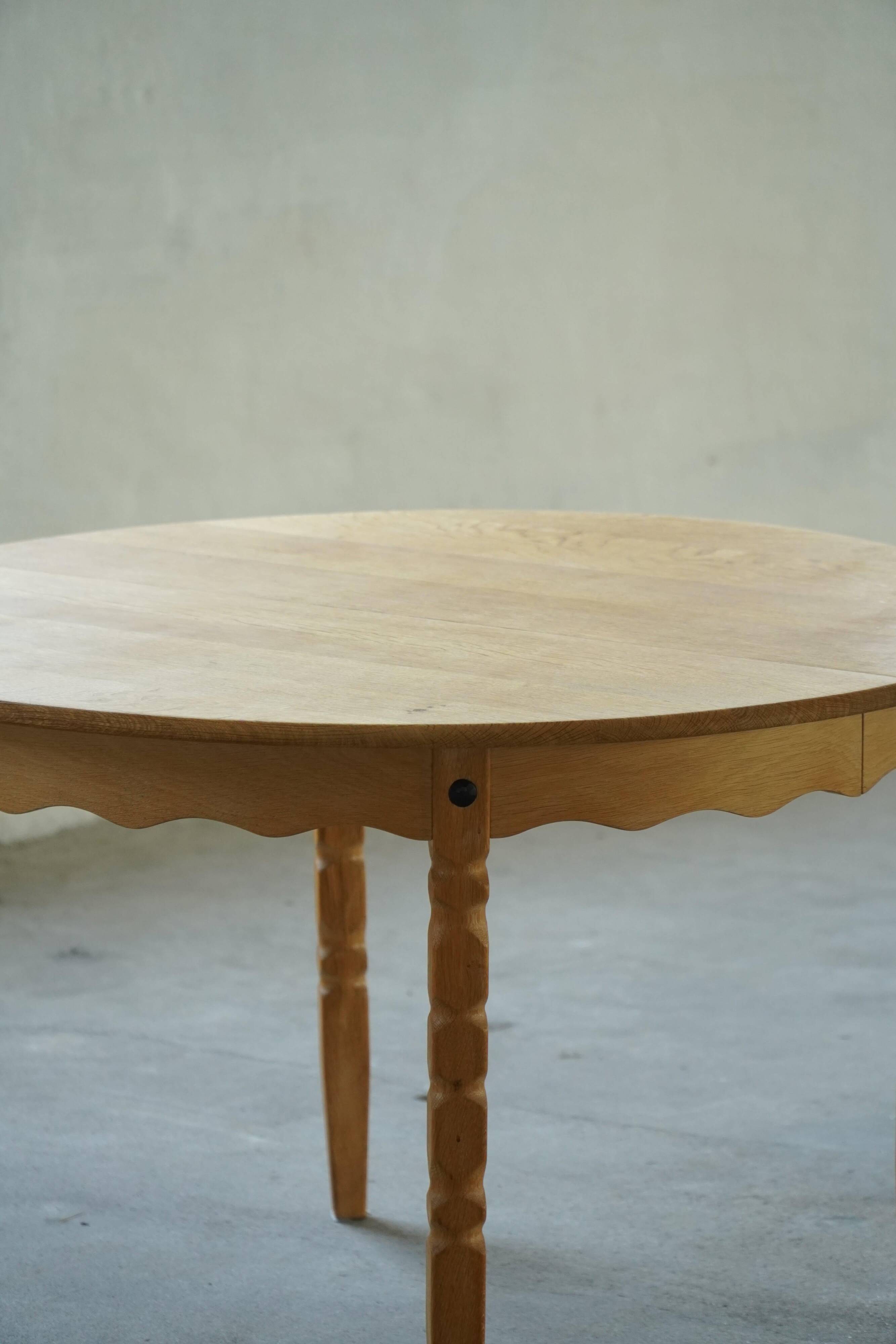 Round solid oak dining table with three extensions, mid-century Danish style, 1960s.