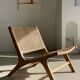 Reclining armchair in natural wood and woven rattan