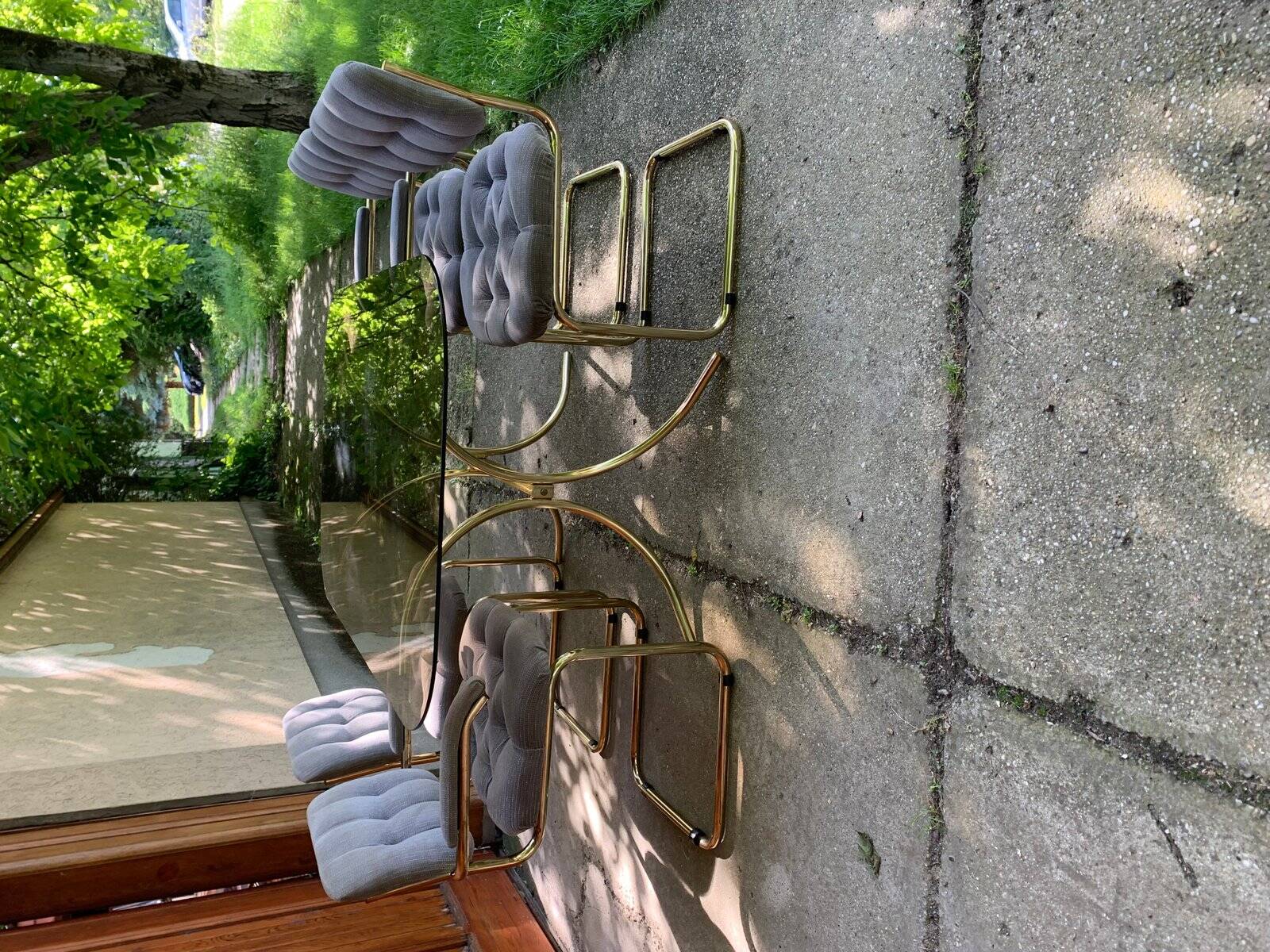 1970s table set with 4 chairs in gold brass and grey fabric, smoked glass top.