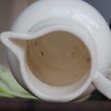 Old pitcher in white earthenware