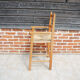Old wooden high chair for children with straw.