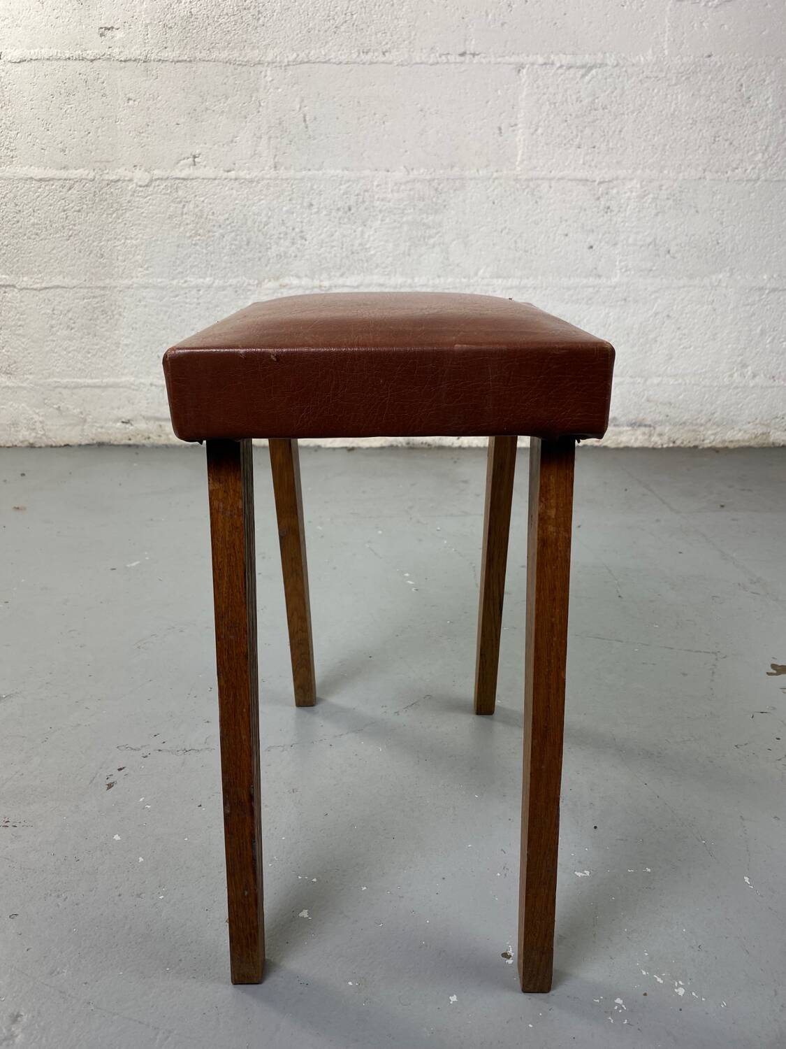 Small stool or footrest in wood and leather