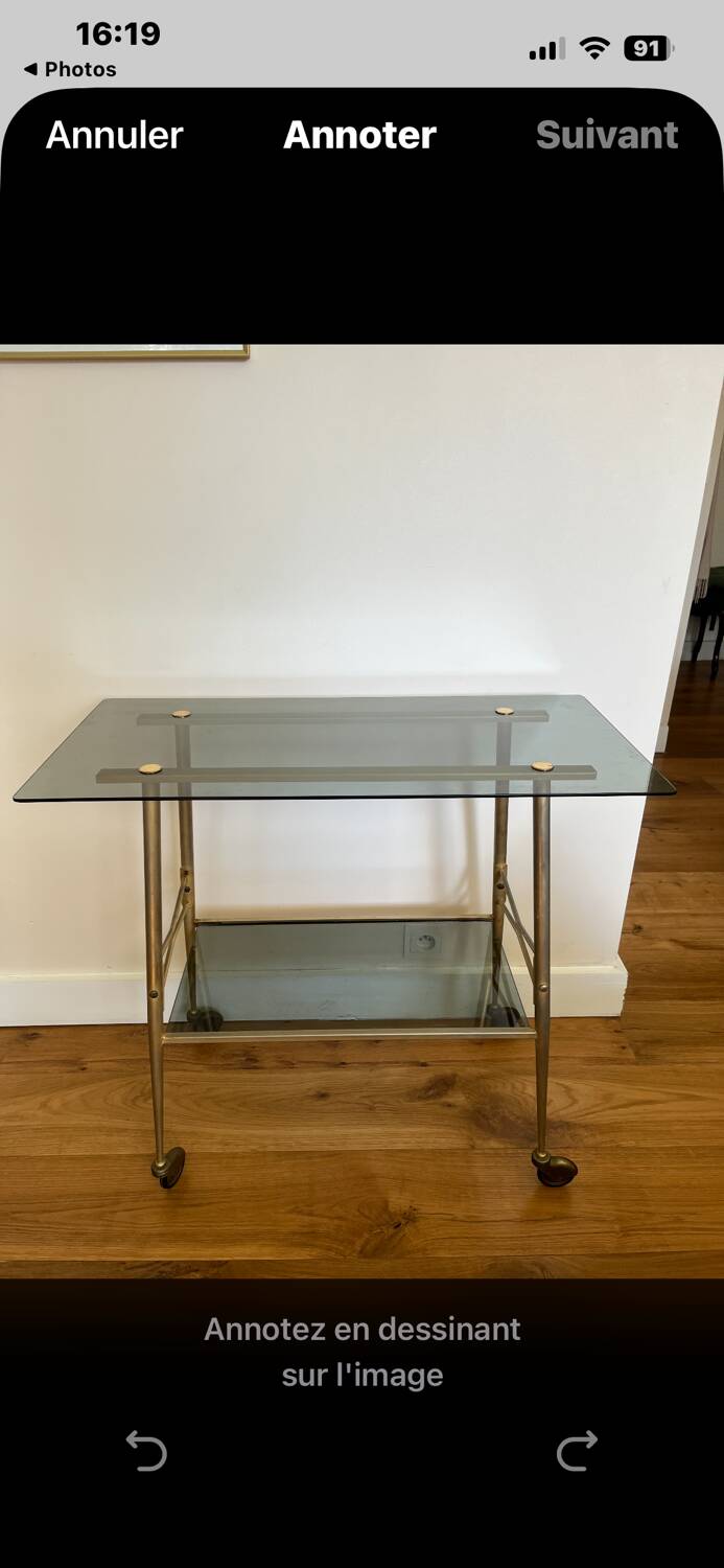 Vintage brass and smoked glass dessert trolley on wheels.