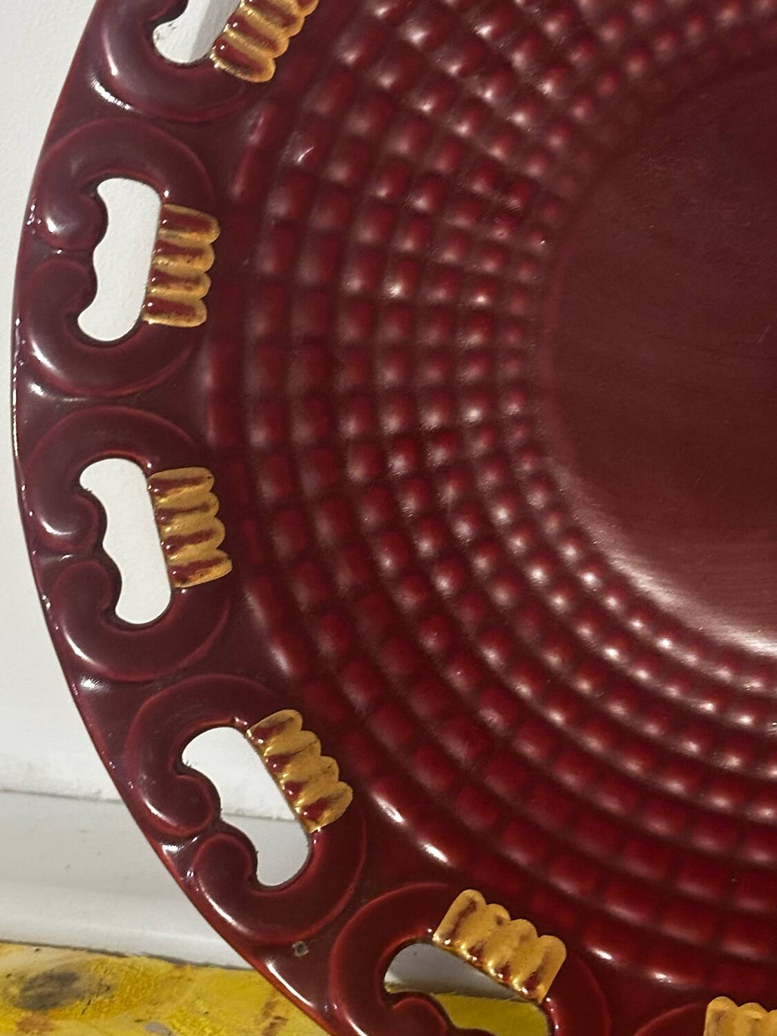 Burgundy and gold openwork plate in ceramic from Saint-Clement, 1950s.