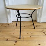 Tripod coffee table with a straw covering.