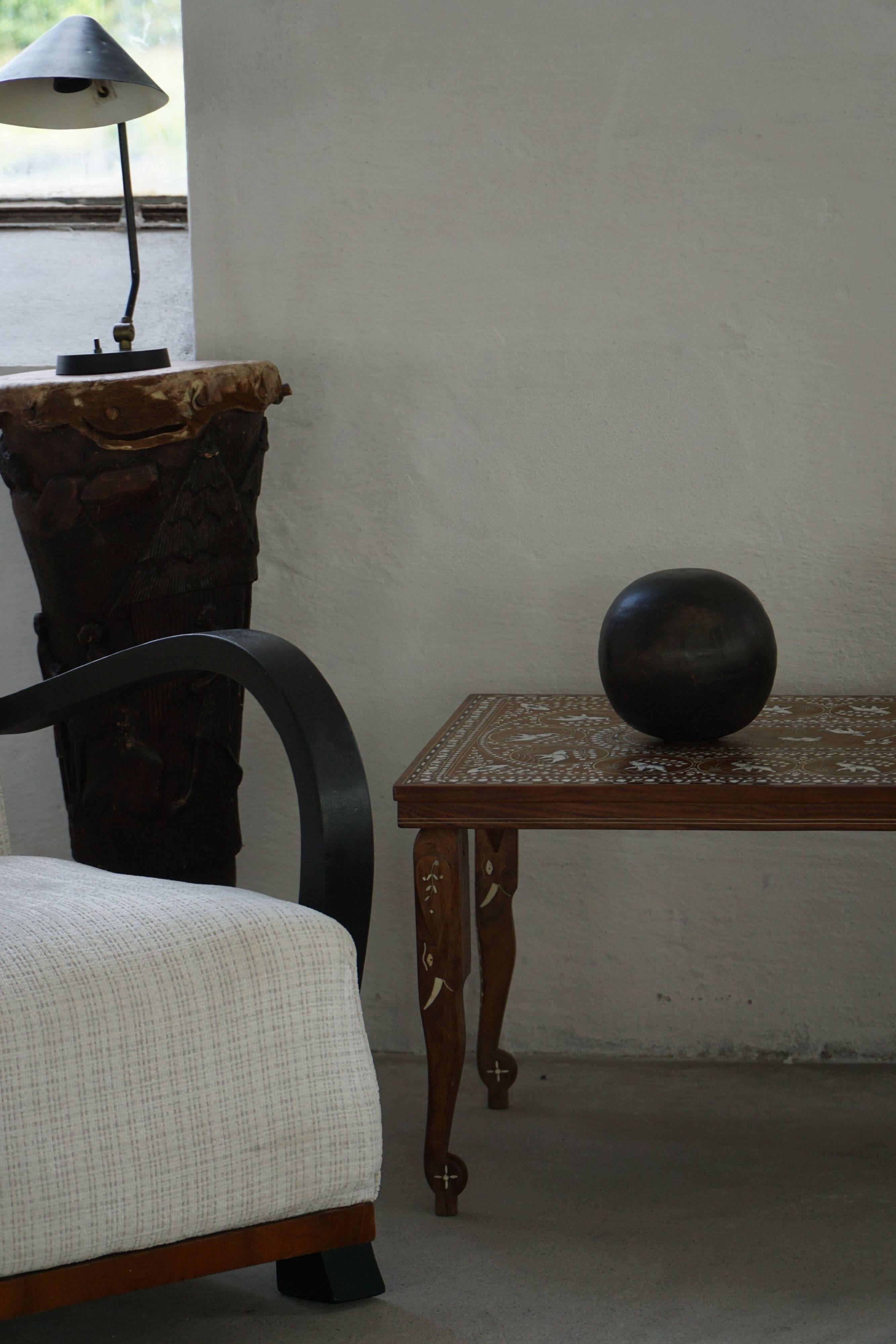 Vintage Indian teak coffee table inlaid with elephant motifs, mid-20th century.