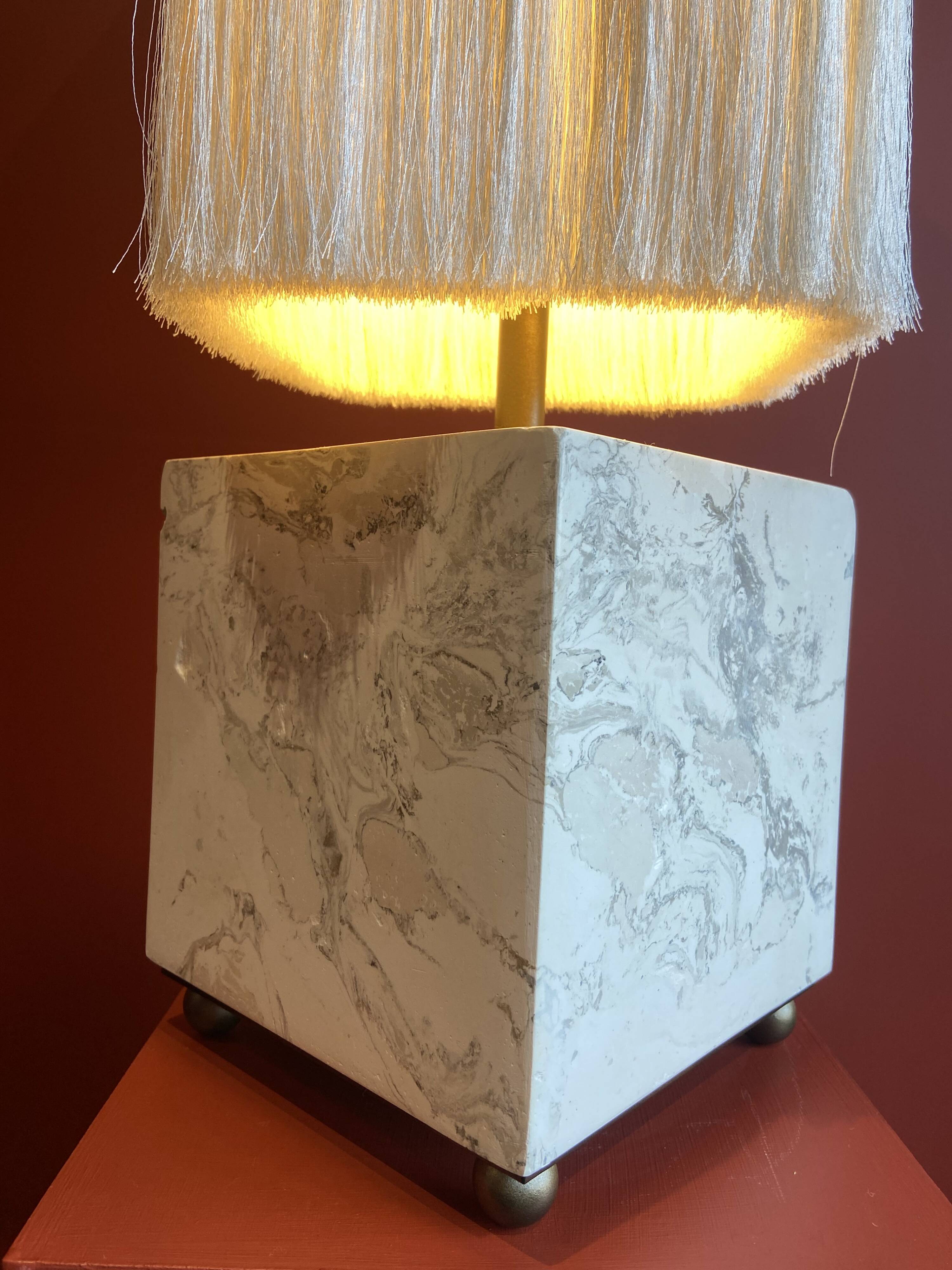 Beige marble stucco base, Houles white ecru fringed lampshade.