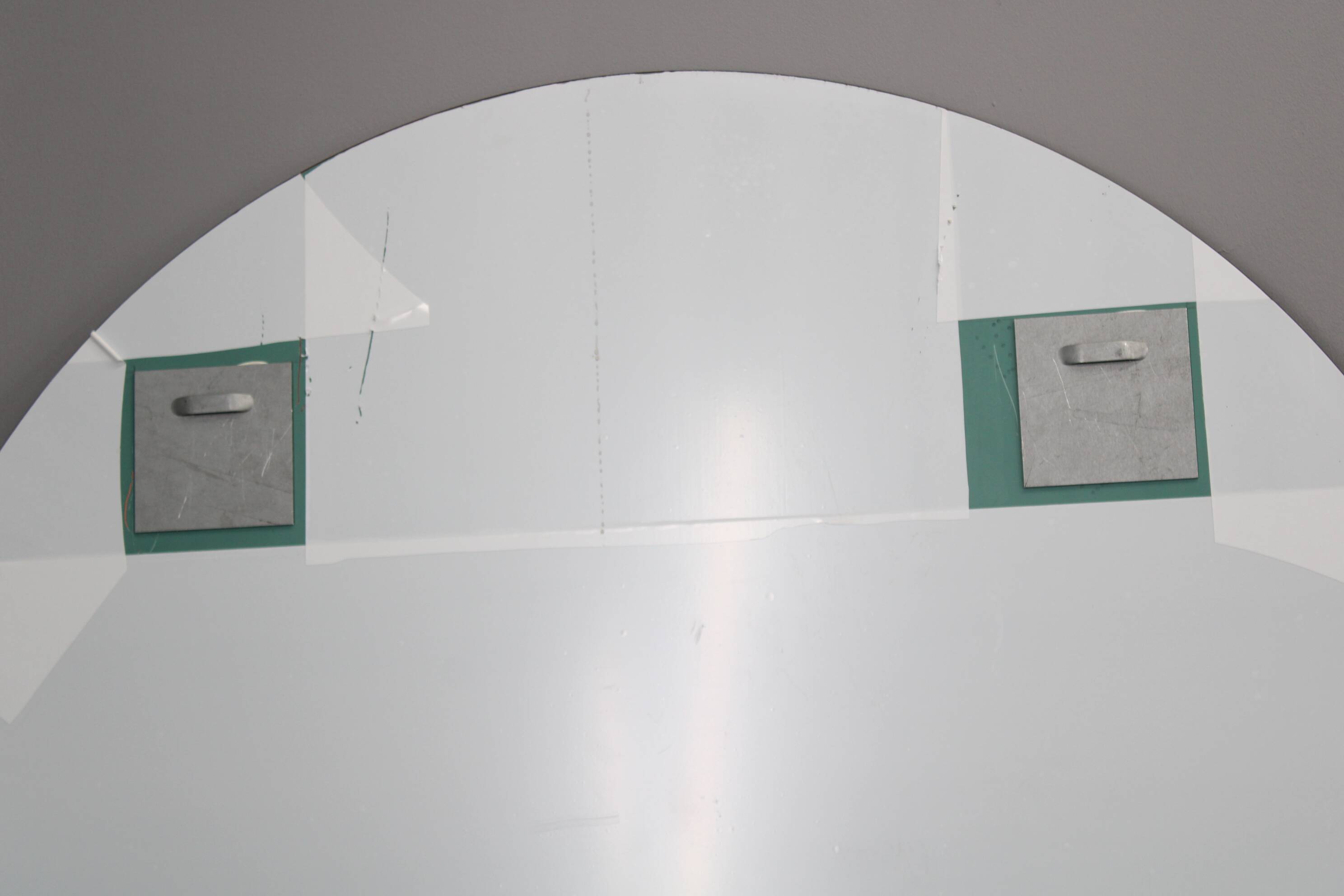 Large 1980s Italian smoke-tinted round mirror with white geometric segment