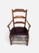 Antique rustic armchair in walnut and leather, 18th century.