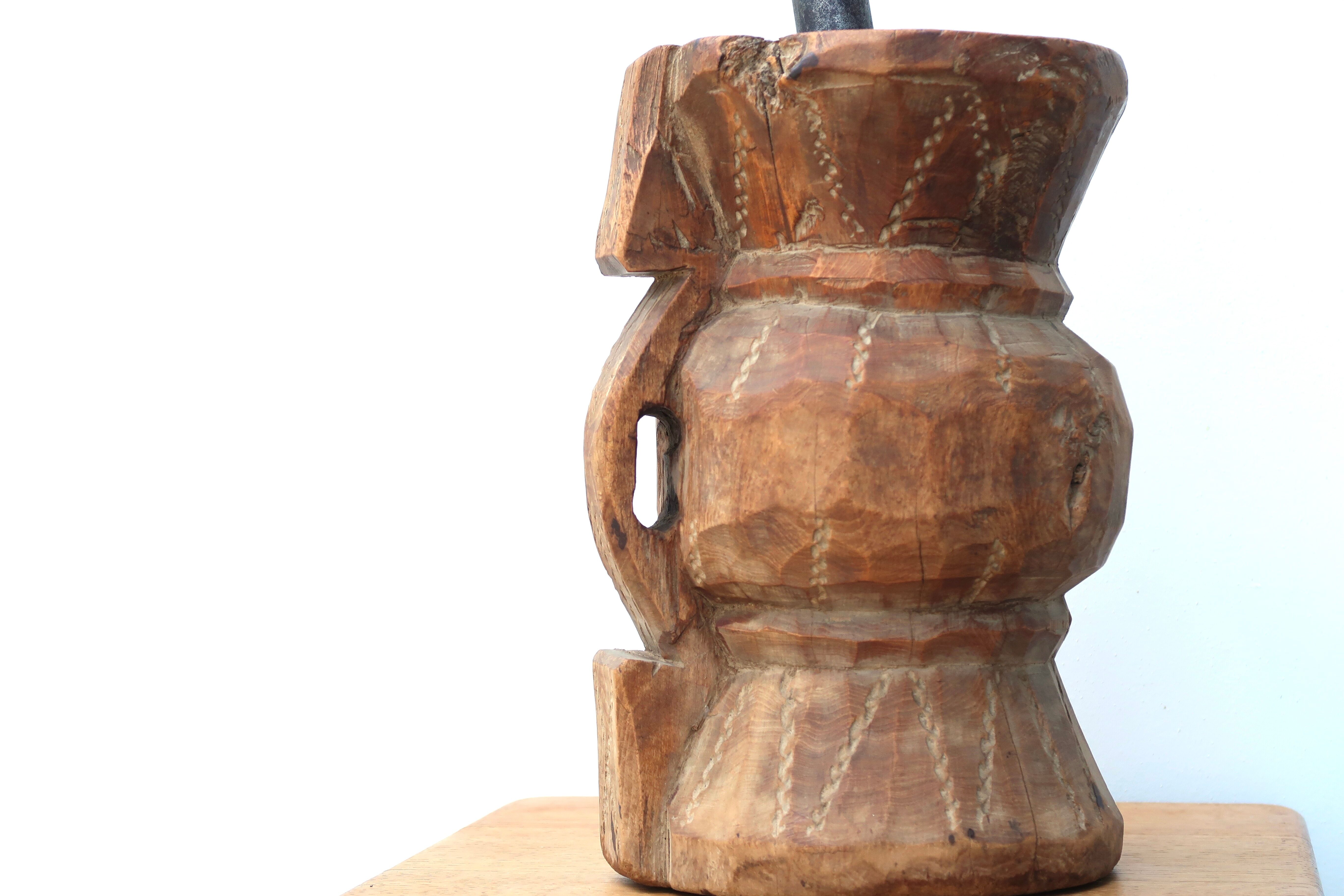 African mortar in carved wood, cast iron pestle, 70s