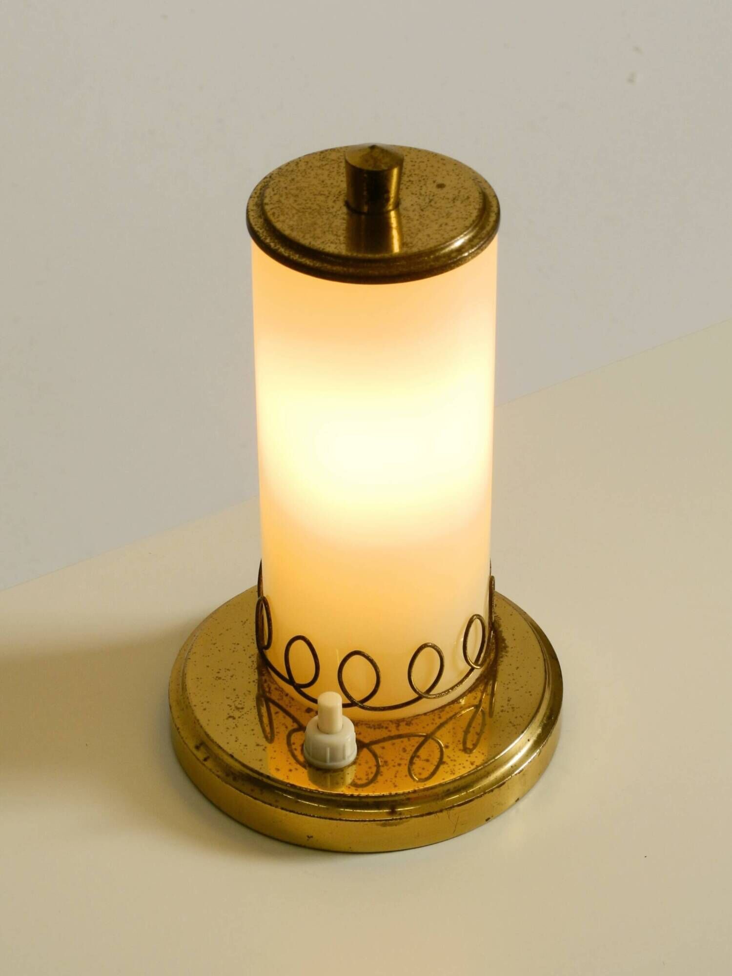 A beautiful, rare 1950s brass table lamp with one opal glass shade adorned