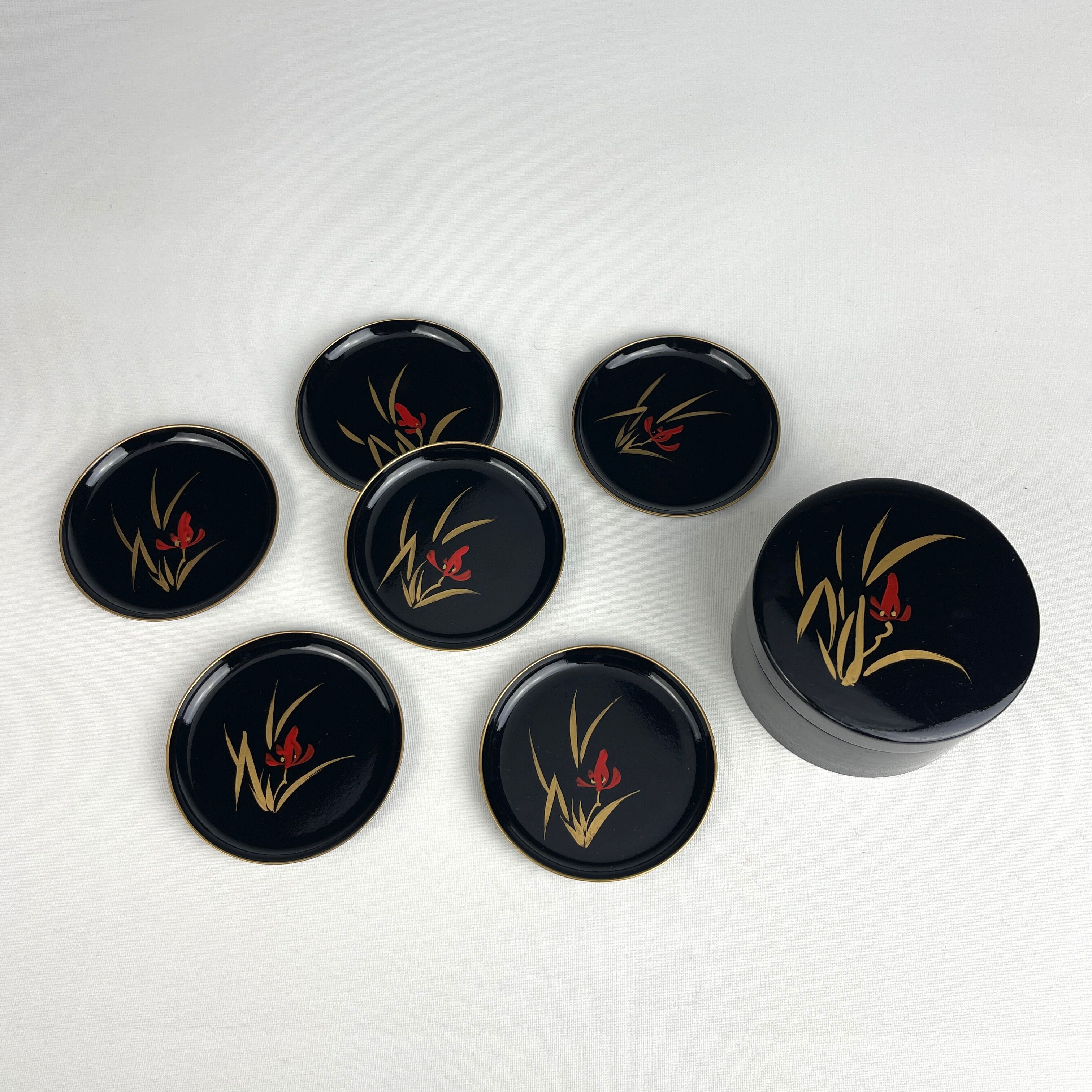 Coasters and their vintage black lacquered wooden box