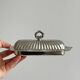 Shiny stainless steel butter dish with lid