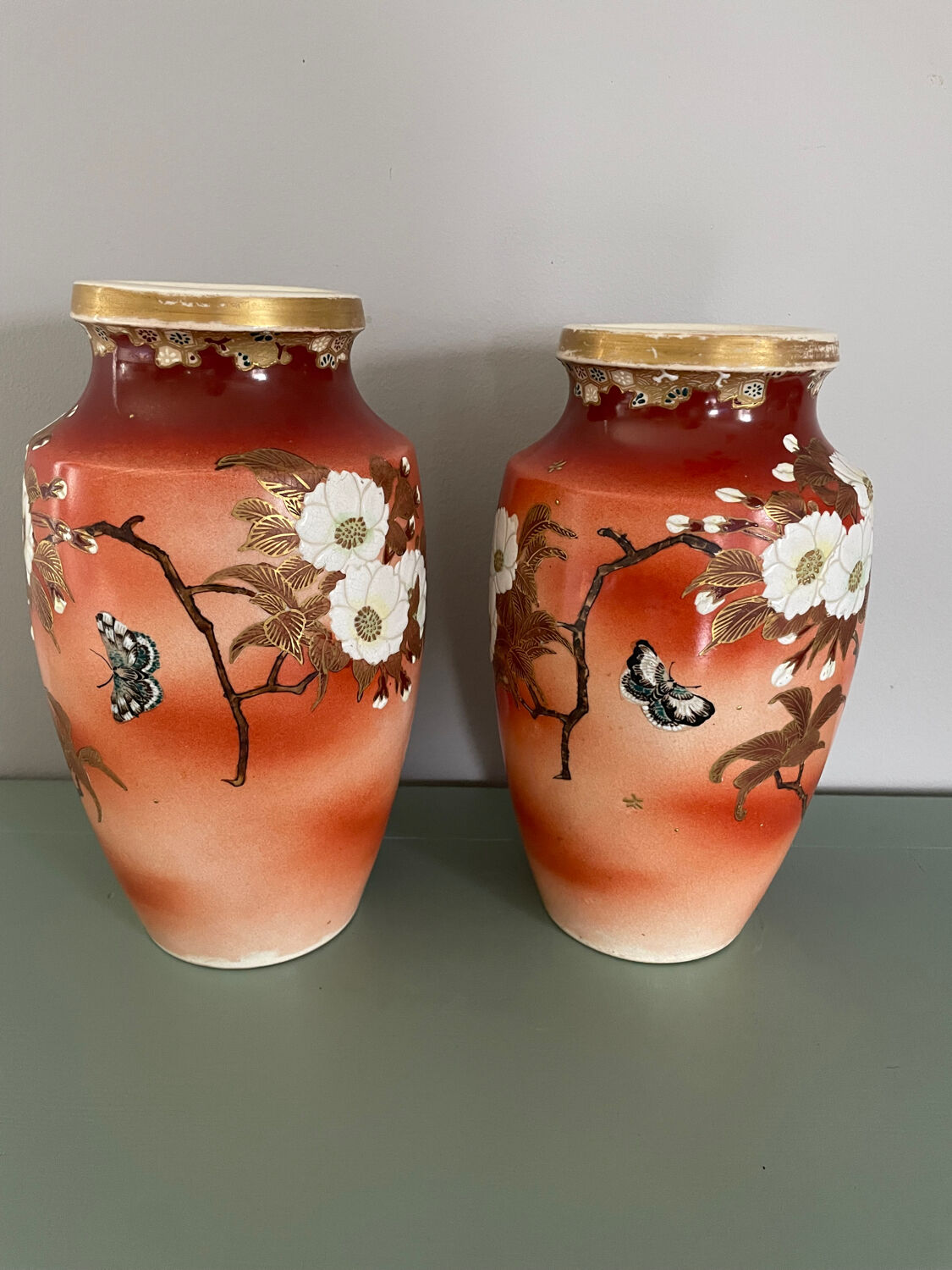 Pair of antique vases with butterfly and flower motif.