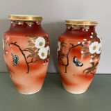 Pair of antique vases with butterfly and flower motif.