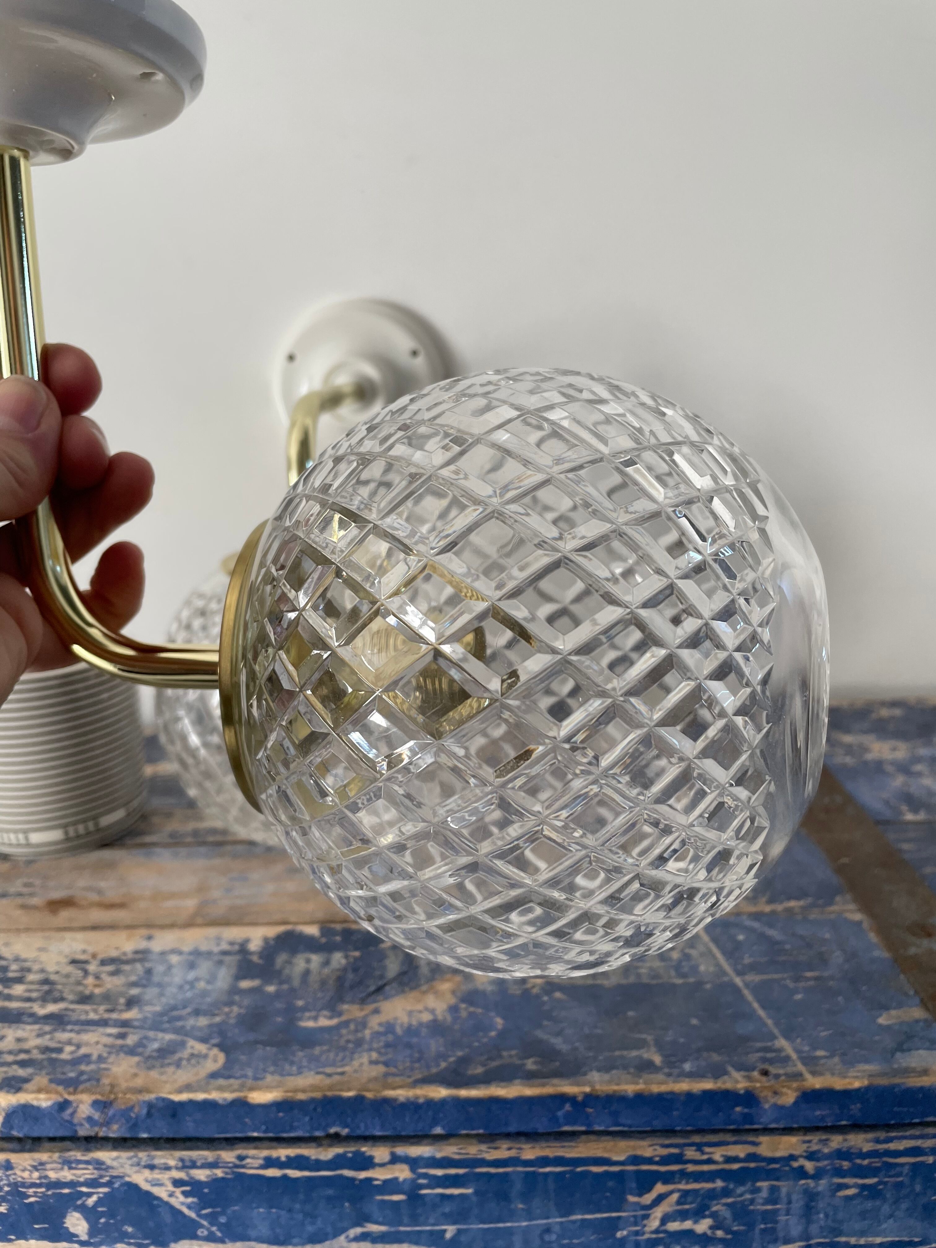 Set of two new electrified chiseled glass globe sconces