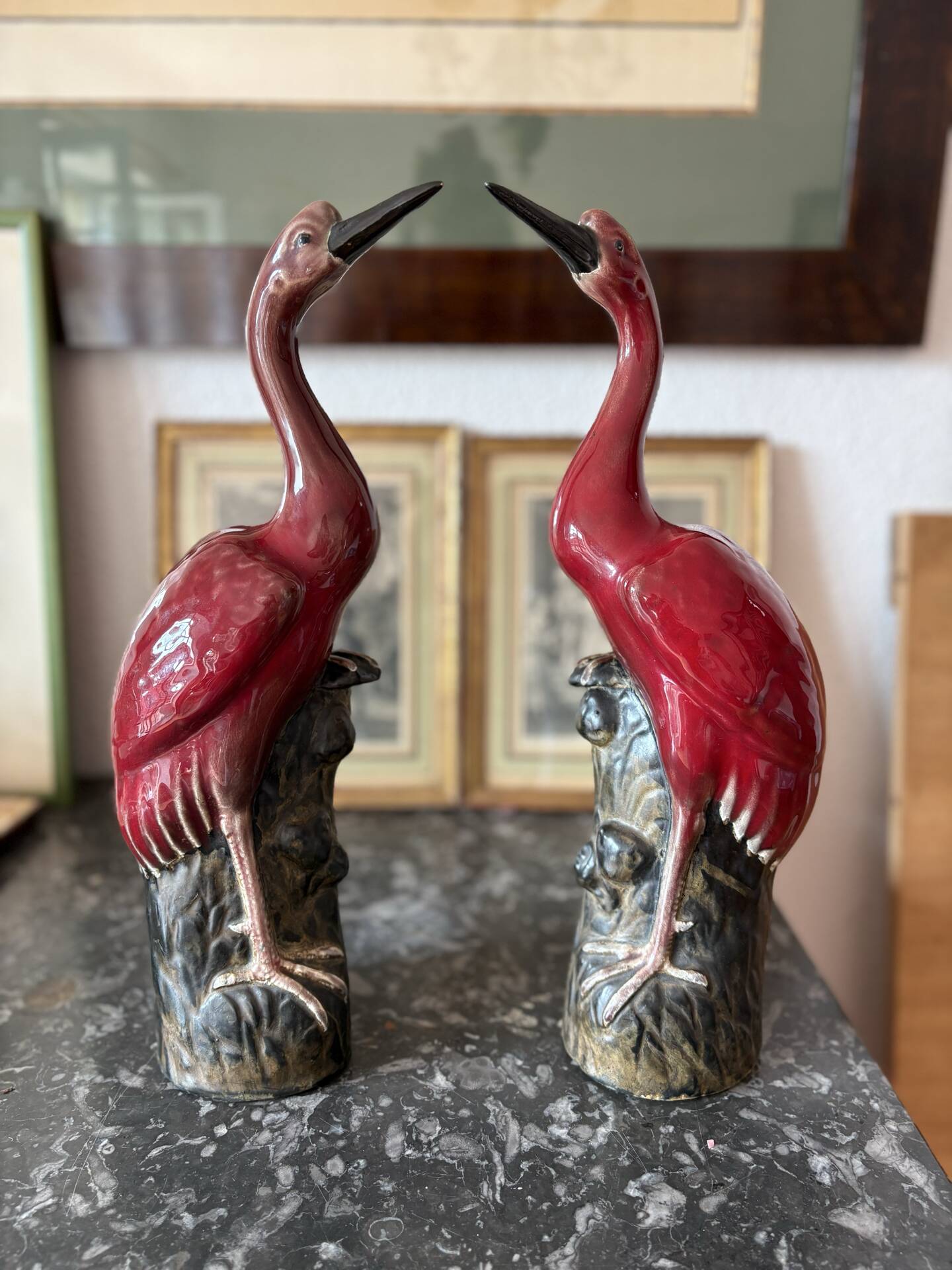 Pair of ceramic red glazed wading bird (crane) figurines.