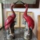 Pair of ceramic red glazed wading bird (crane) figurines.