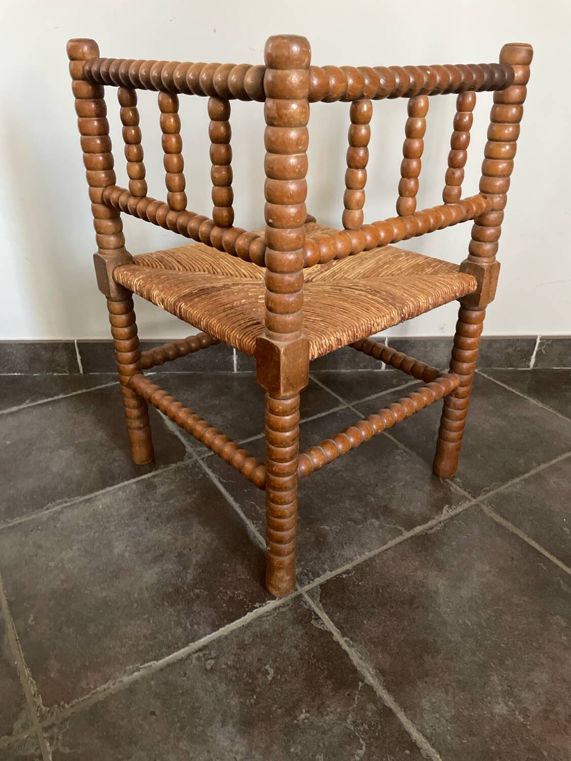 Old armchair, corner chair, made of wood and straw