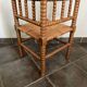 Old armchair, corner chair, made of wood and straw