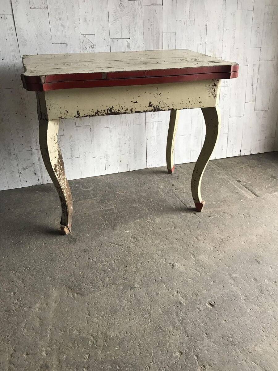 Rustic red and cream wooden dining table, moulded top, 1950s.