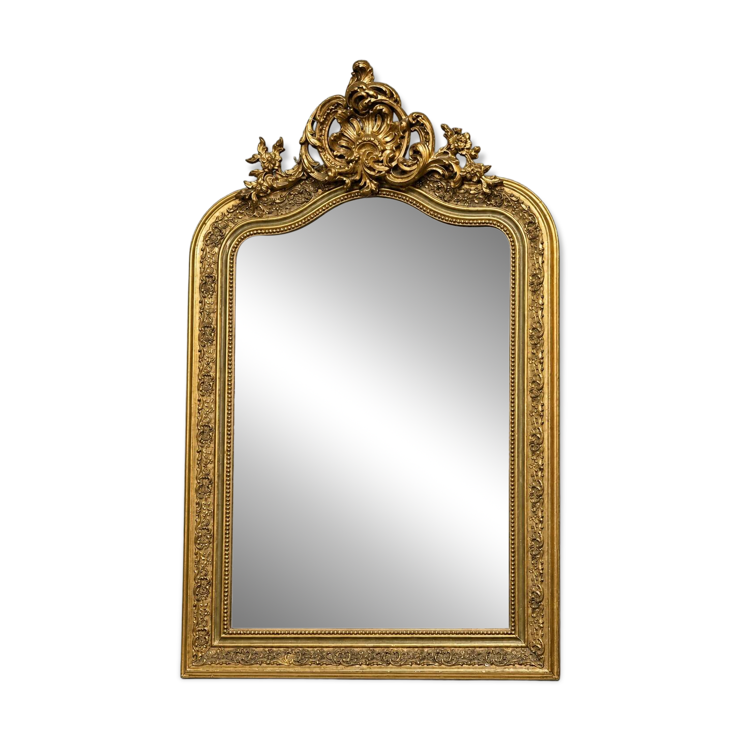 Large carved and gilded wooden mirror, rectangular in shape.