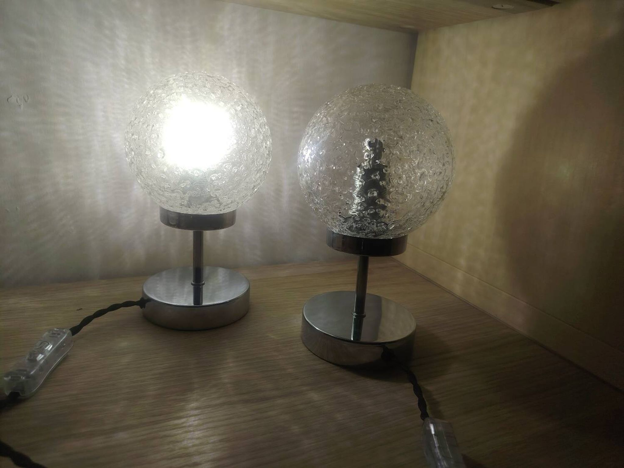 Duo of textured globe lamps with a large play of light.