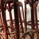 Series of 9 bistro bar stools in curved wooden restaurant sitting red fabric