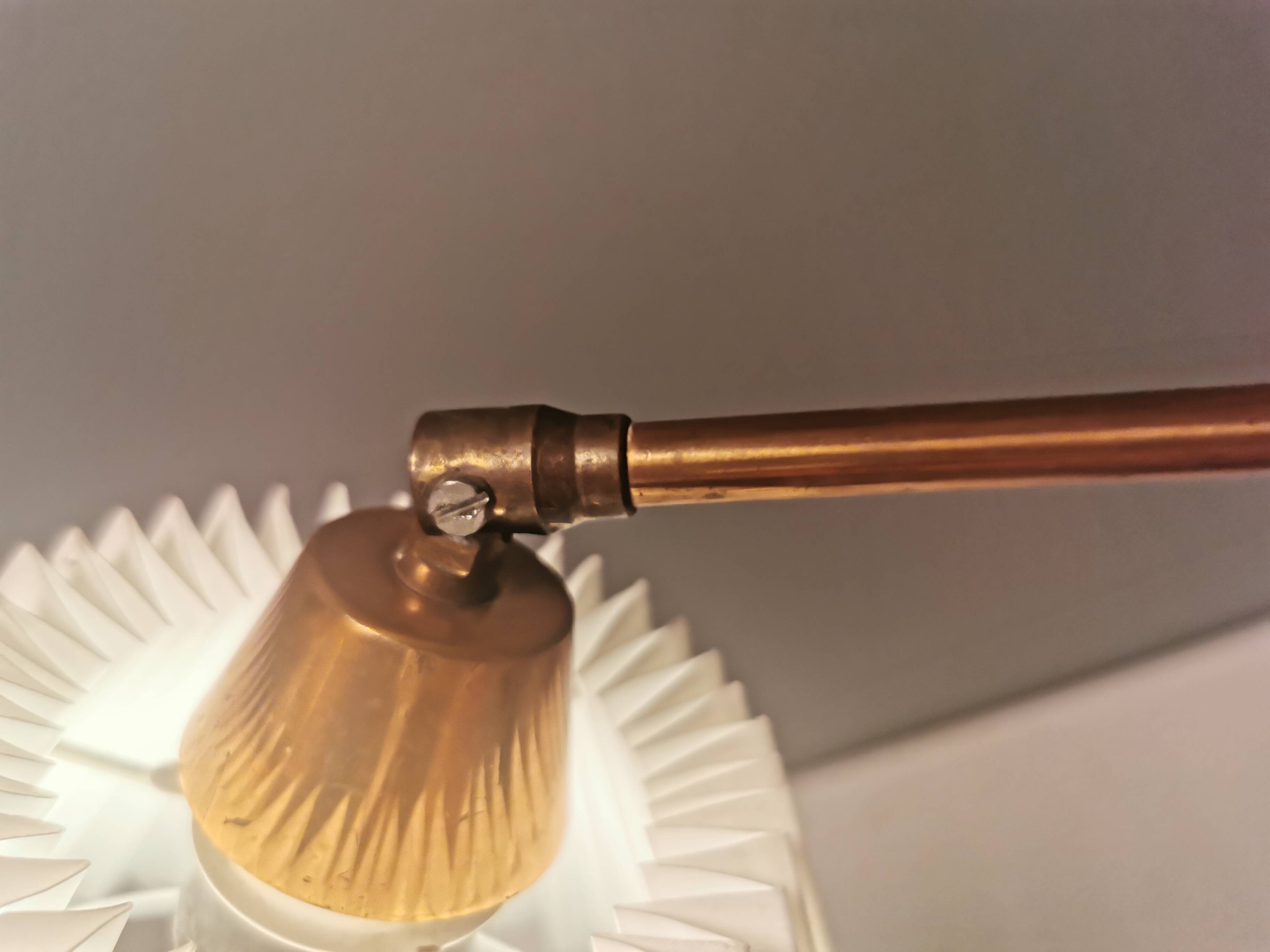 Wall lamp with adjustable ‘arm’ in copper and rosewood, with white shade.