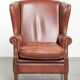 Cognac-coloured cow leather wingback armchair in English style