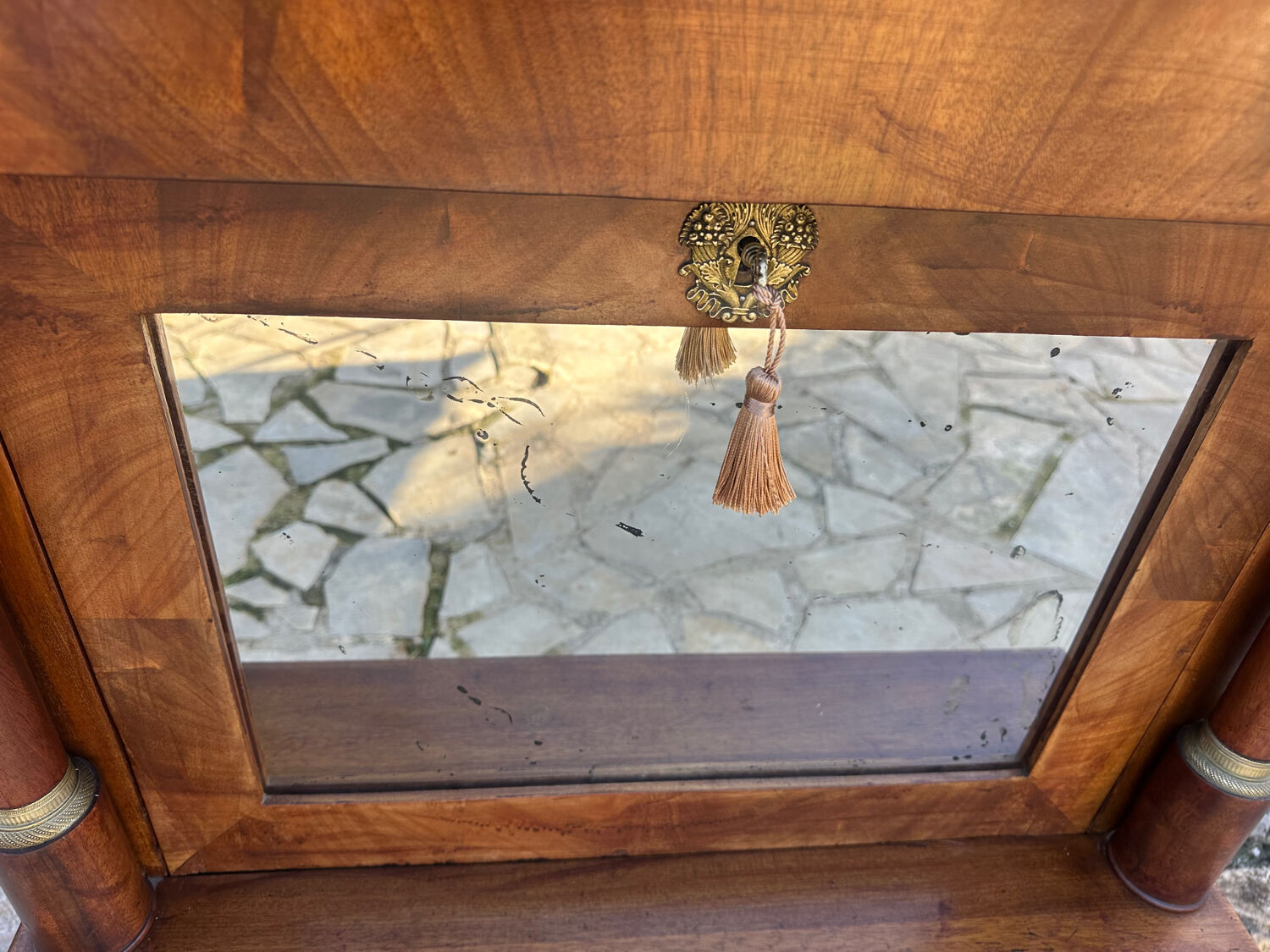 A small piece of Bonheur du jour with detached columns in Empire-era mahogany.