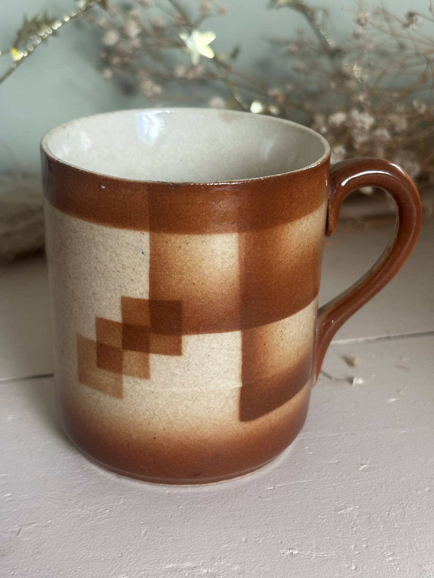 Vintage 70s old ceramic mug with a brown cubic graphic pattern.