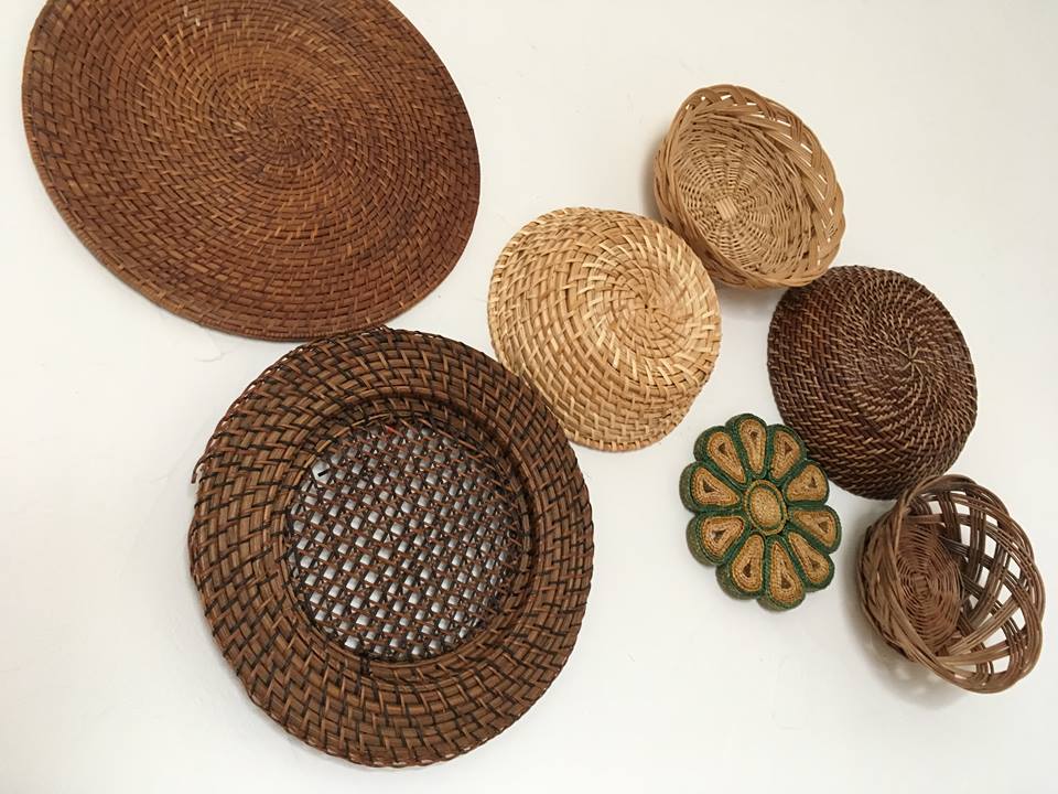 Wall composition of seven baskets and wicker trays.