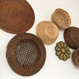 Wall composition of seven baskets and wicker trays.