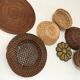 Wall composition of seven baskets and wicker trays.