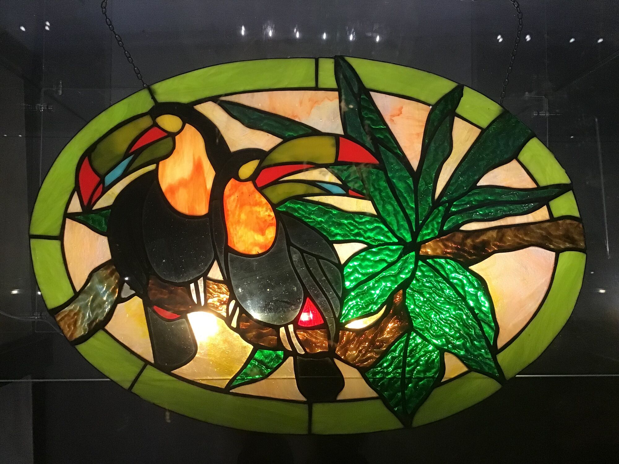 Art Deco style stained glass window representing a couple of toucans