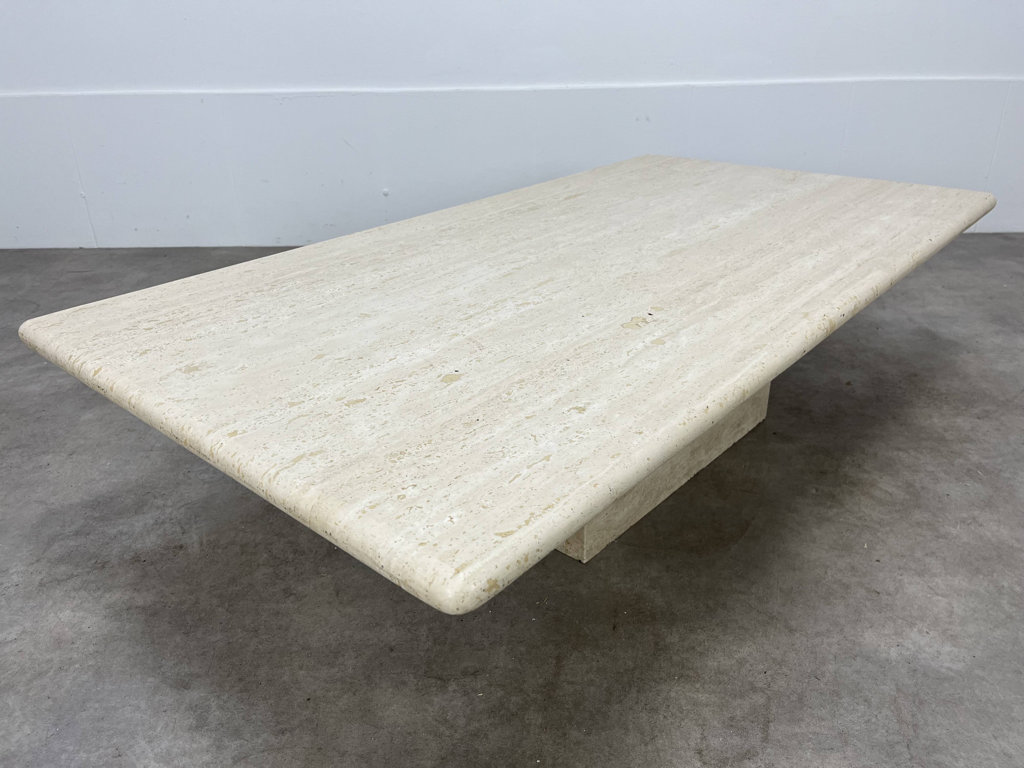 Rectangular travertine coffee table with central leg