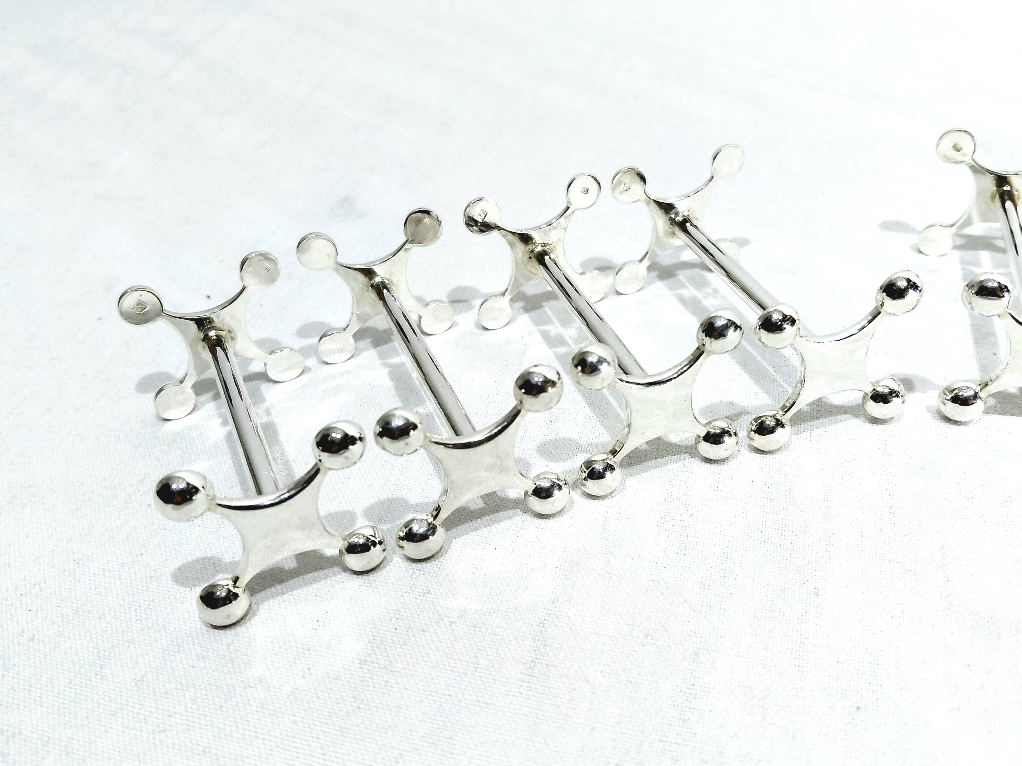 SET OF 12 SILVER-PLATED KNIFE RESTS
