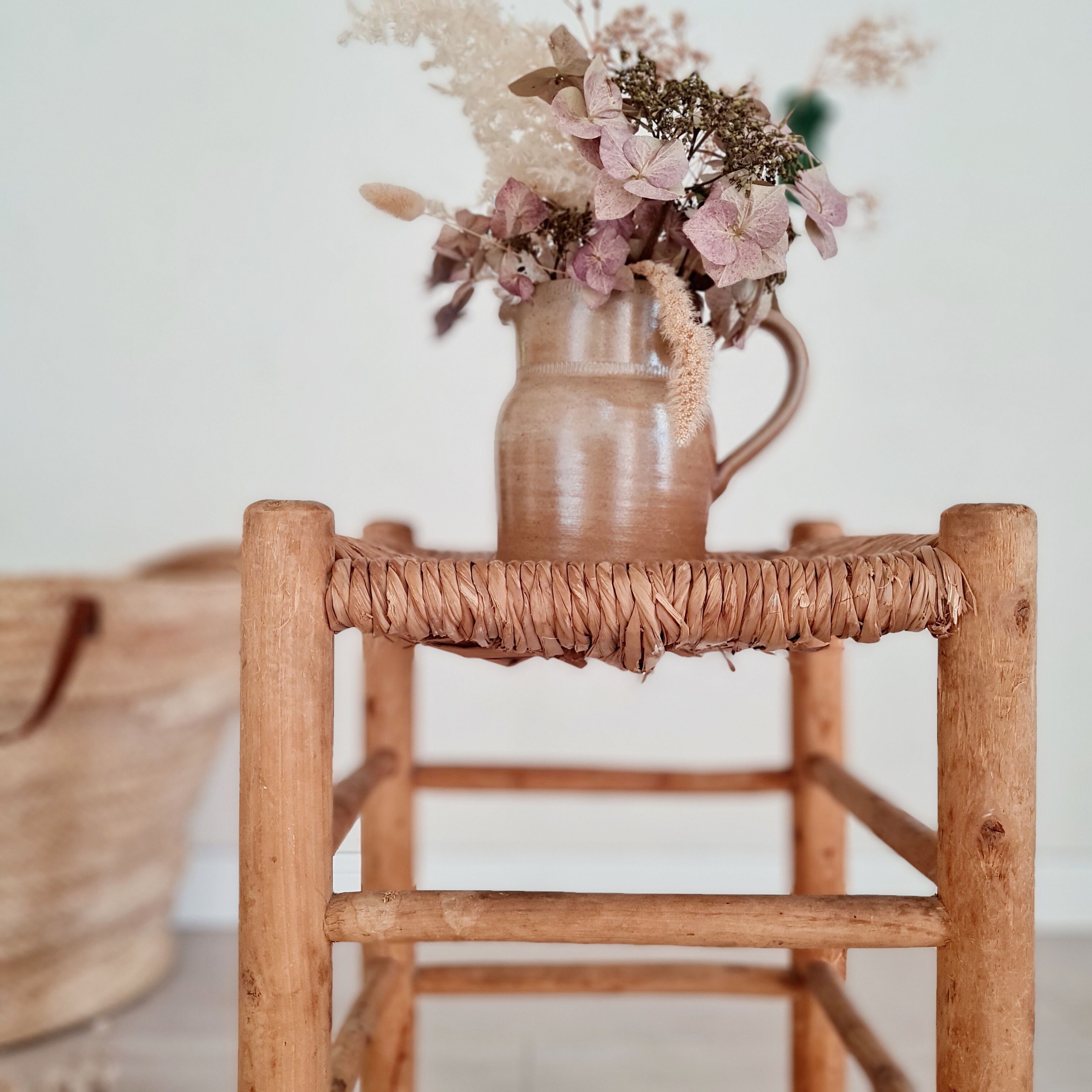 Old stool in wood and straw brutalist look