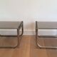 Pair of side tables in chrome, blackened wood and glass.
