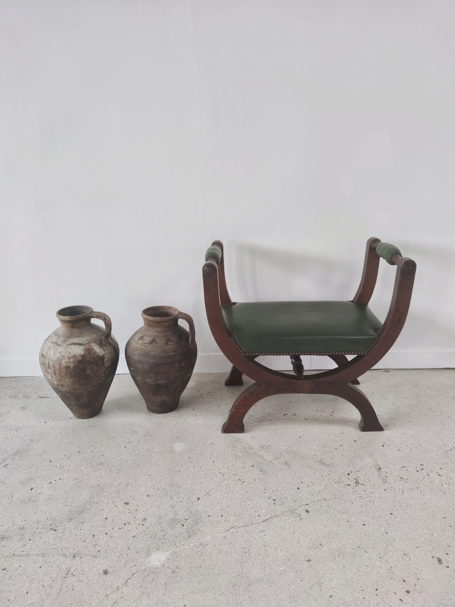 Green curule armchair