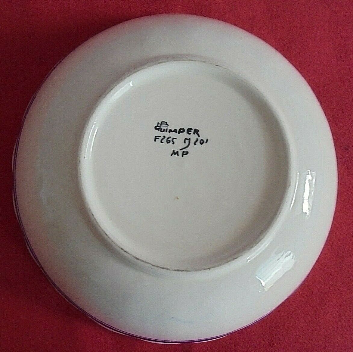 Round flat hollow Breton motifs signed HR Quimper
