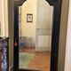 Black wardrobe with a mirrored door in ebony finish.