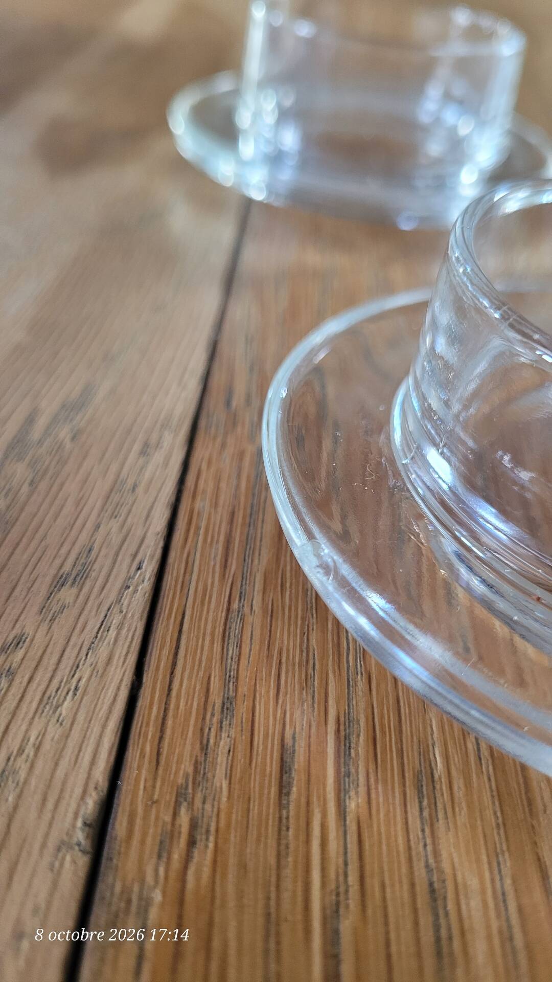 2 transparent glass butter dishes accompanied by their matching cloches.