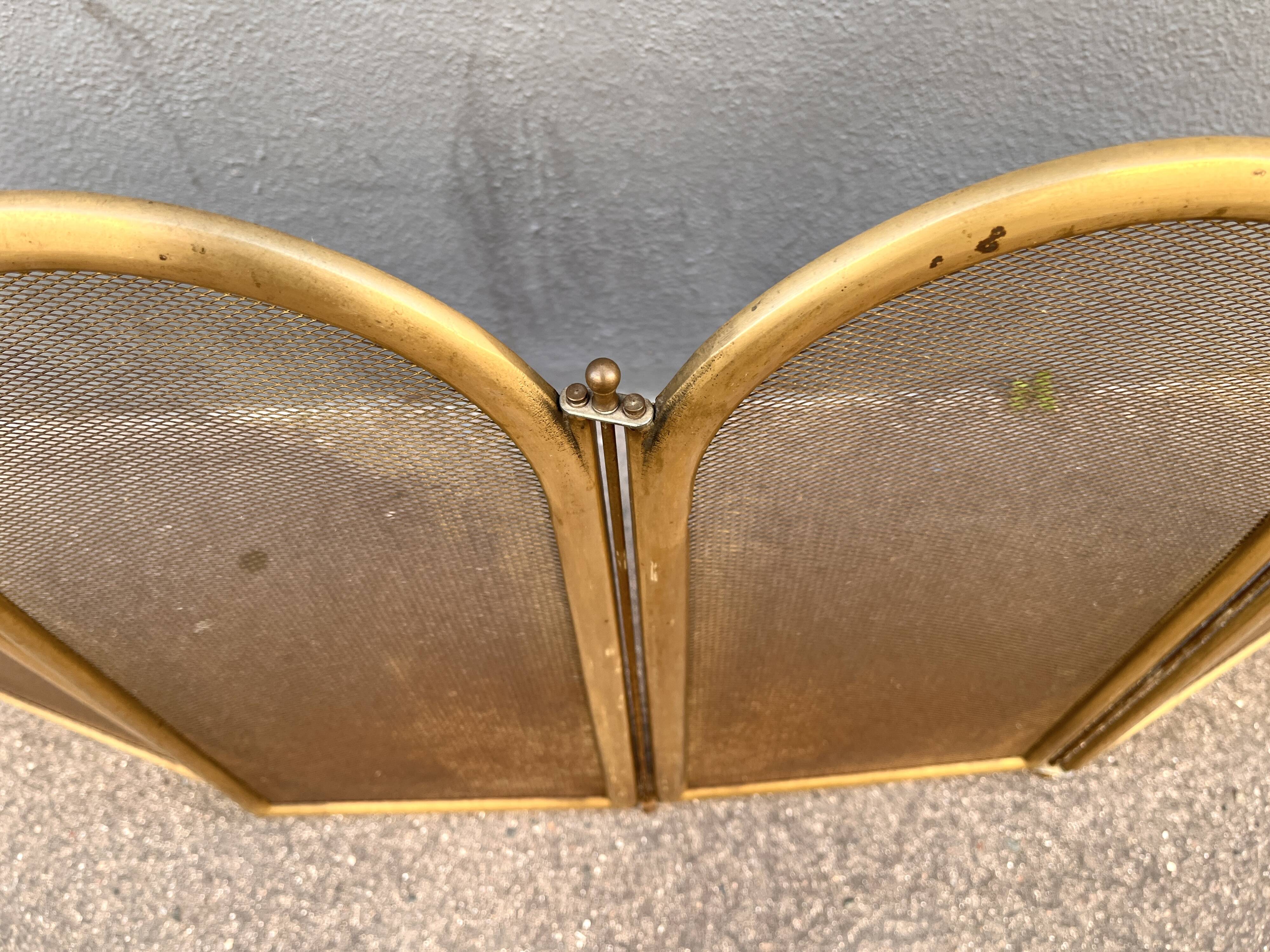 Antique brass fireplace screen from 1920, vintage spark guard.